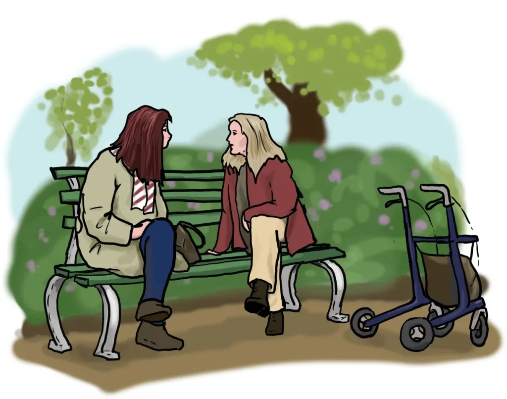 2 Frauen unterhalten sich auf einer Bank im Park.